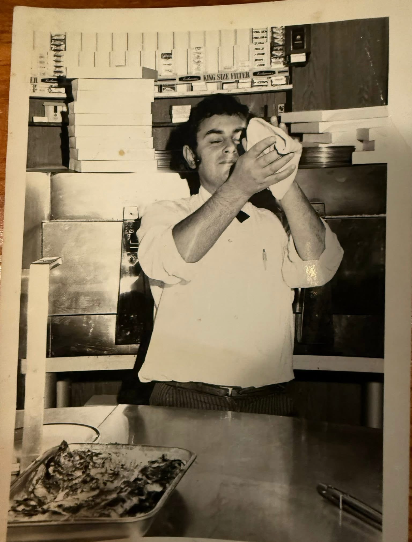 An original photograph of a cook working with dough in an Italian kitchen